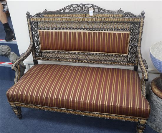 A late 19th/early 20th century ebony and porcupine quill sofa by H Don Carolis and Sons, Colombo W.122cm